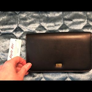 Black Buxton wallet with lots of extras.